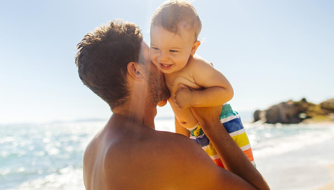 father-holding-baby-beach.jpg